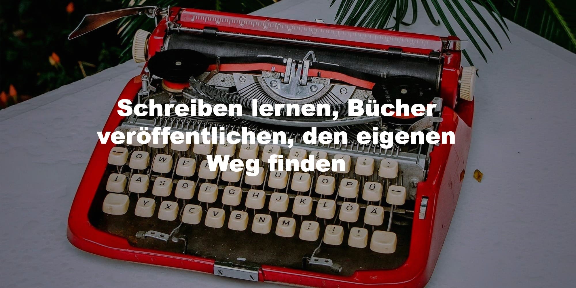 Rote Schreibmaschine auf Schreibtisch, Symbol für kreatives Schreiben, Selfpublishing und Blogtipps auf The Story to Be